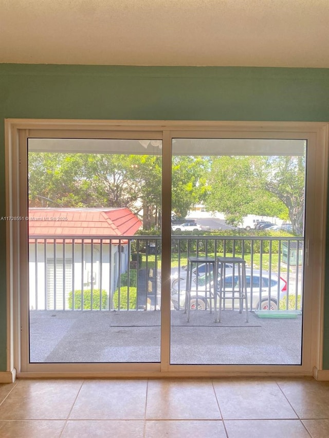 doorway to outside featuring a healthy amount of sunlight and tile patterned floors