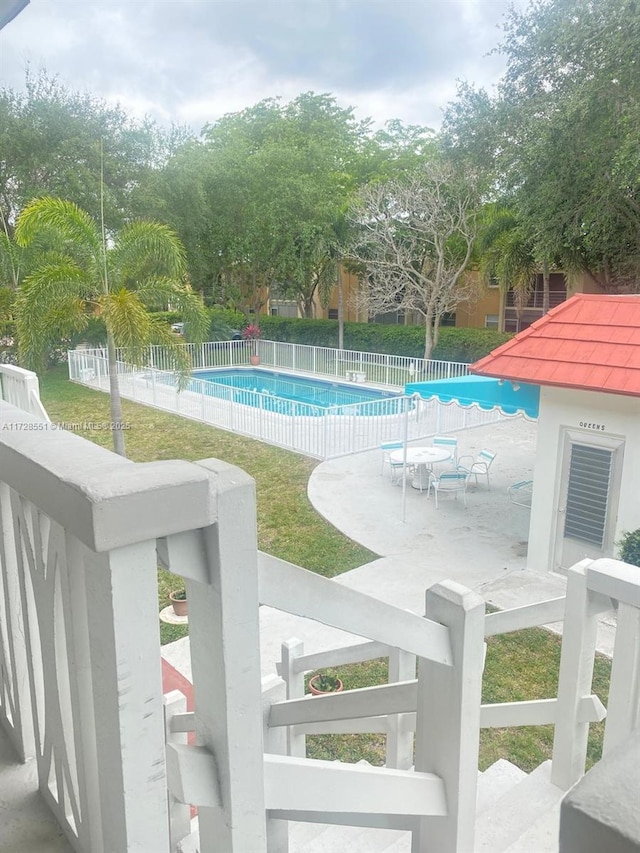 view of pool with a yard and a patio area