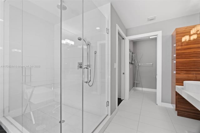 bathroom with tile patterned floors, vanity, and a shower with shower door