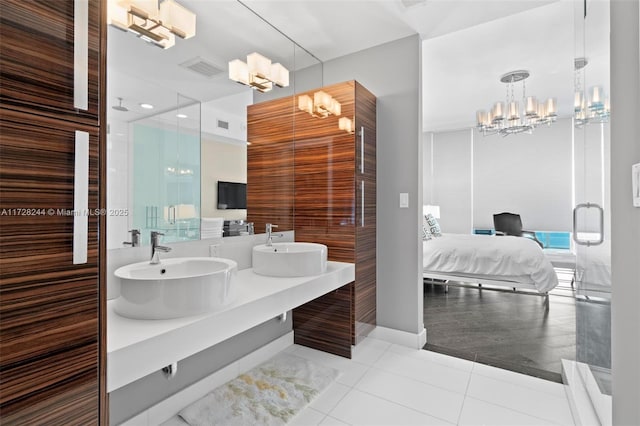 bathroom with an inviting chandelier, tile patterned floors, an enclosed shower, and vanity