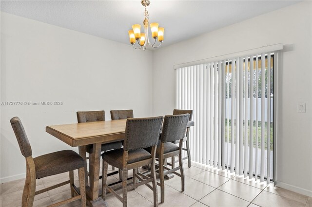 dining room with plenty of natural light, light tile patterned floors, and a chandelier