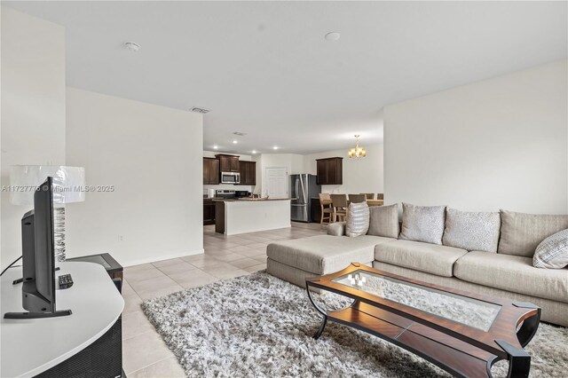 tiled living room featuring a notable chandelier