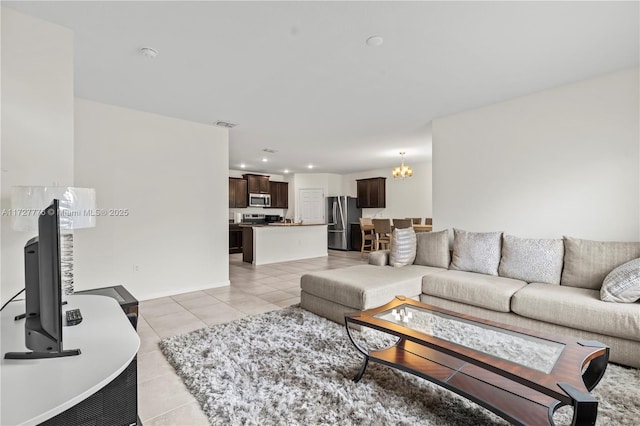 living room with light tile patterned floors, recessed lighting, baseboards, and a chandelier