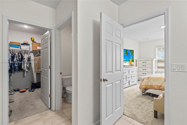 bathroom with toilet and tile patterned flooring