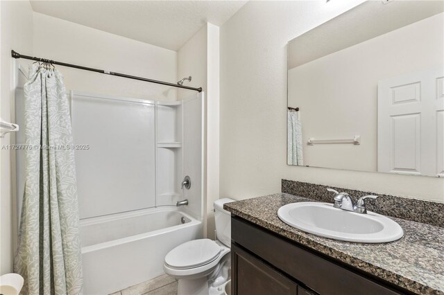 full bathroom featuring tile patterned flooring, toilet, vanity, and shower / tub combo with curtain