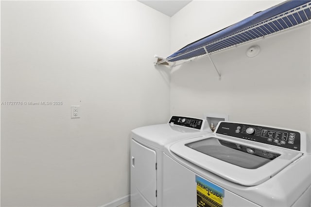 washroom featuring washer and clothes dryer