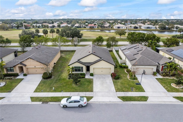 birds eye view of property featuring a residential view and a water view