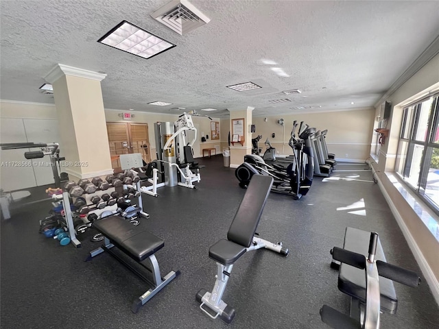 exercise room featuring ornamental molding and a textured ceiling