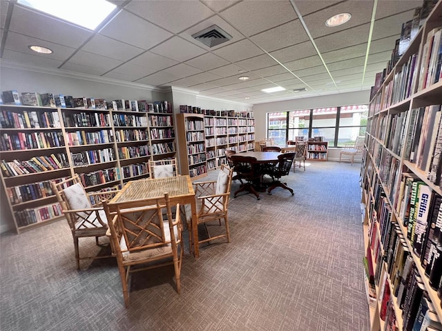 office space with a paneled ceiling, crown molding, and carpet floors