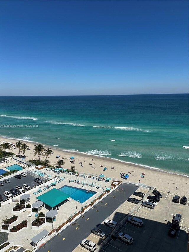 birds eye view of property with a view of the beach and a water view