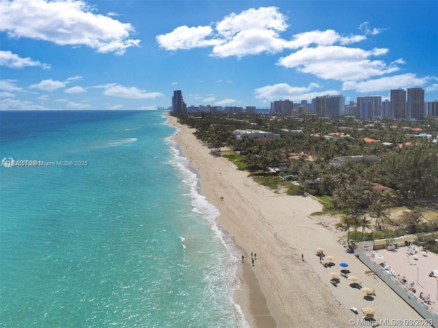 birds eye view of property with a water view and a view of the beach