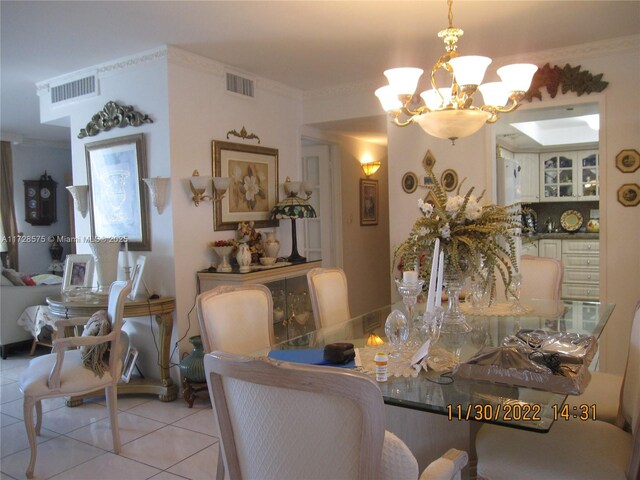 dining room with light tile patterned floors, a chandelier, and ornamental molding