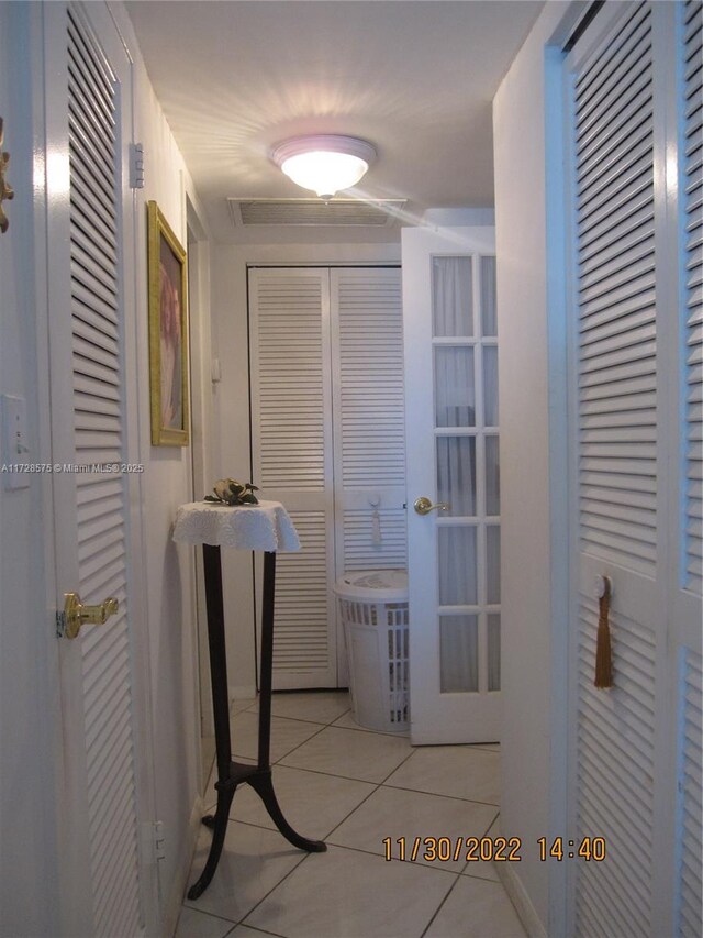 hall with light tile patterned floors and french doors