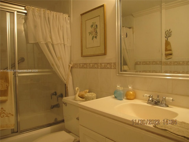 full bathroom featuring toilet, tile walls, enclosed tub / shower combo, and vanity