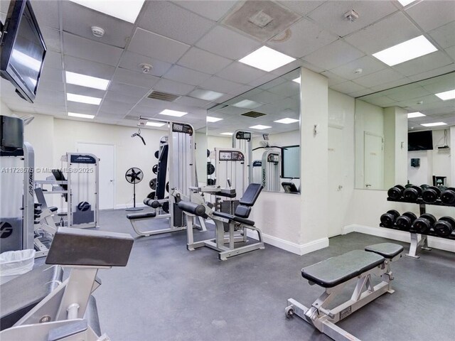 gym with a paneled ceiling