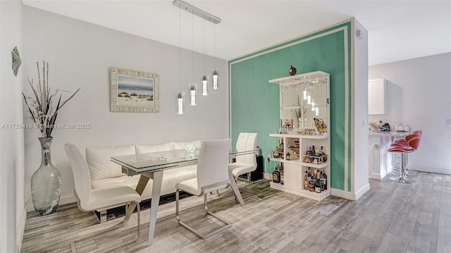 dining space with hardwood / wood-style floors