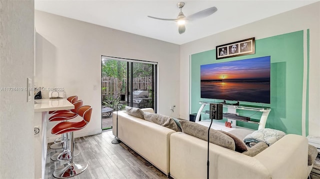 living room with ceiling fan and wood-type flooring