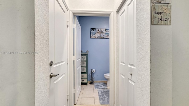 corridor featuring light tile patterned floors