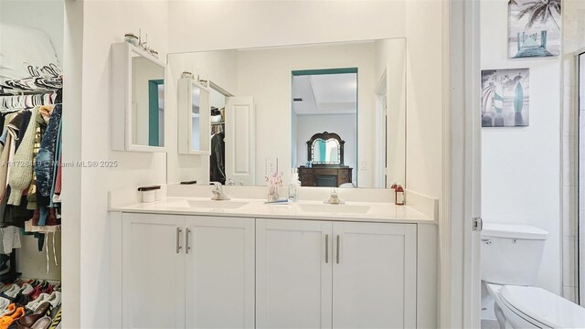 bathroom featuring toilet and vanity