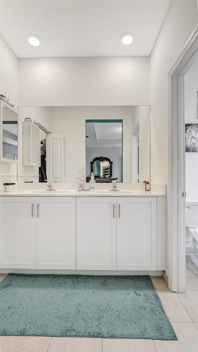 bathroom with tile patterned floors, vanity, and toilet