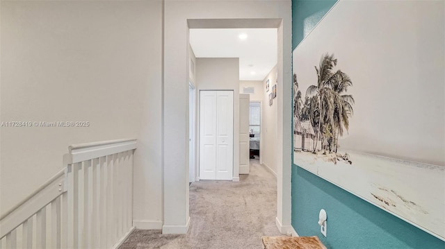 corridor with light colored carpet