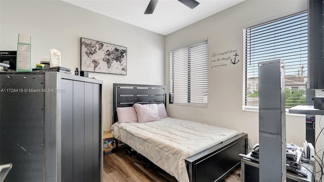 bedroom with ceiling fan and hardwood / wood-style floors