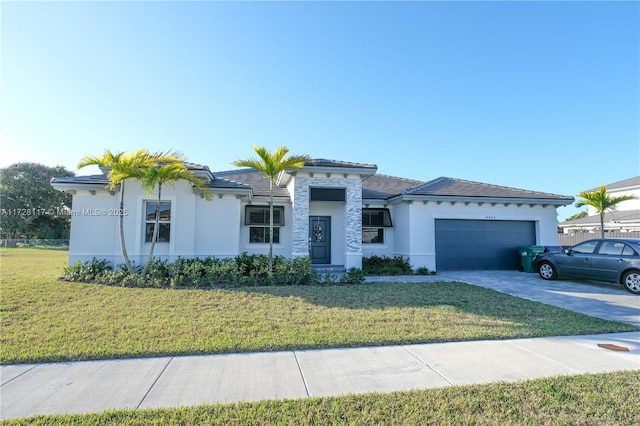 view of front of home with a garage and a front lawn