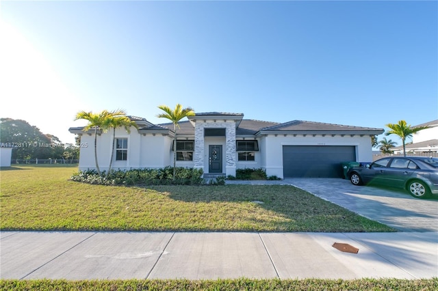 mediterranean / spanish home with a garage and a front lawn