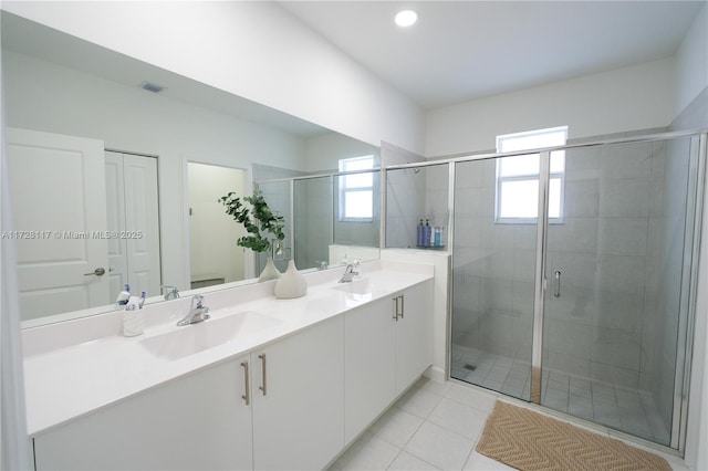 bathroom featuring vanity, a shower with door, and tile patterned flooring