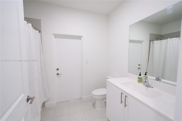 bathroom featuring tile patterned flooring, vanity, and toilet