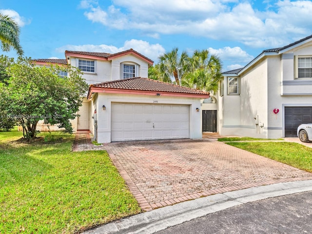 view of front of home with a garage and a front lawn