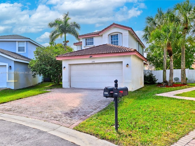 view of front of house with a front yard and a garage