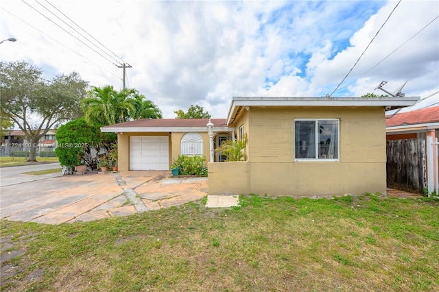 bungalow with a front yard and a garage