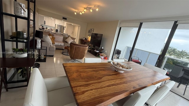 dining room with floor to ceiling windows and light tile patterned floors