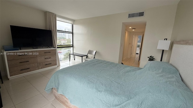 bedroom with light tile patterned floors