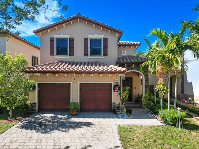 mediterranean / spanish house with a garage