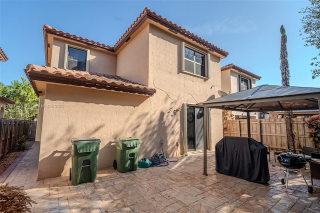 back of house featuring a gazebo and a patio area