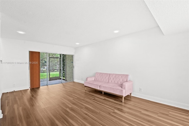 unfurnished room featuring a textured ceiling and hardwood / wood-style floors