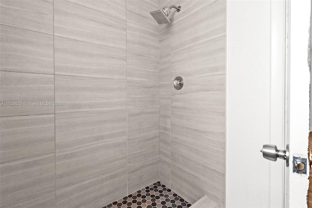 bathroom with tiled shower