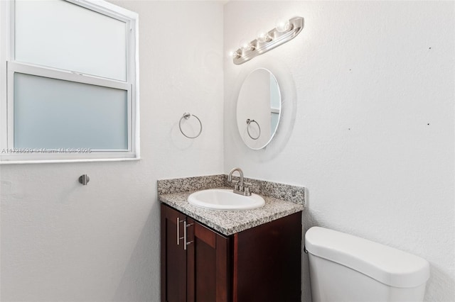 bathroom with toilet and vanity