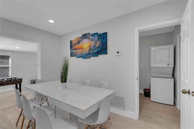 dining room featuring stacked washer and dryer