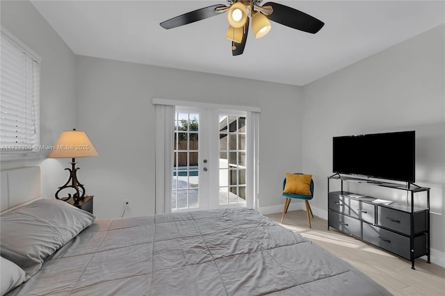 bedroom featuring ceiling fan, access to exterior, light hardwood / wood-style flooring, and french doors