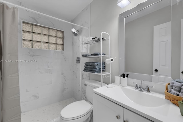 bathroom with toilet, vanity, and tiled shower