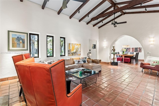 tiled living room with beam ceiling, ceiling fan, and high vaulted ceiling