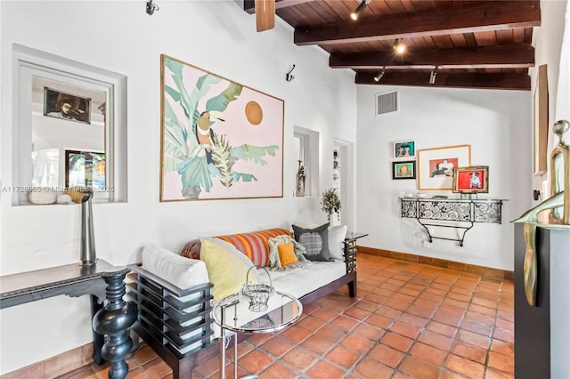 living room featuring tile patterned floors, wood ceiling, and vaulted ceiling with beams