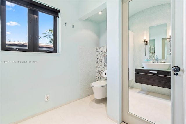 bathroom featuring toilet, vanity, and tile patterned floors