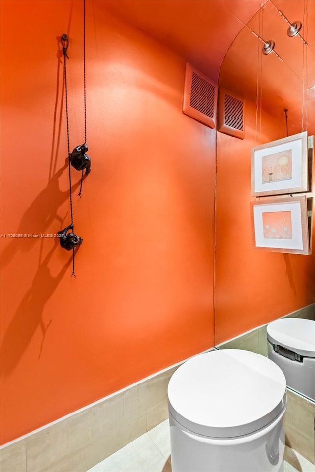 bathroom featuring toilet and tile patterned flooring