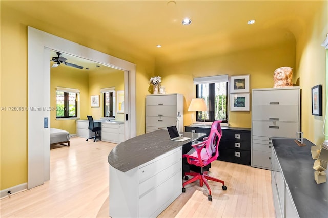 office area featuring ceiling fan, a wealth of natural light, and light hardwood / wood-style flooring