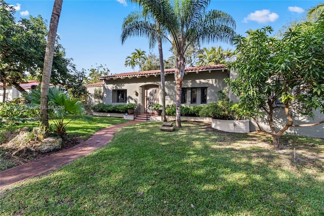 mediterranean / spanish home featuring a front yard