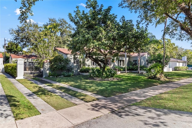 mediterranean / spanish home featuring a front yard